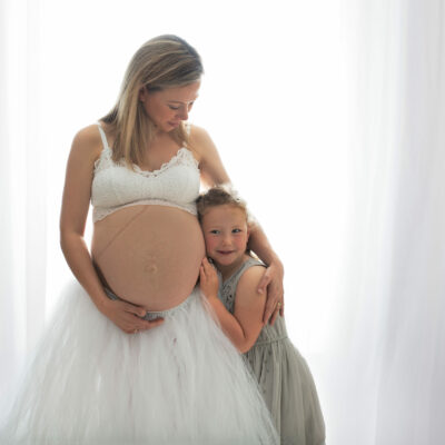 Maternity photoshoot. Mum-to-be and daughter. Photographer Cheryl Catton at home studio in Woking.