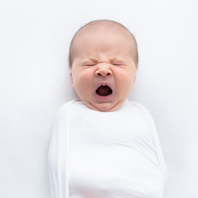 Newborn baby photography photo shoot. Yawning baby. Photographer of photo shoot is Cheryl Catton , Woking.