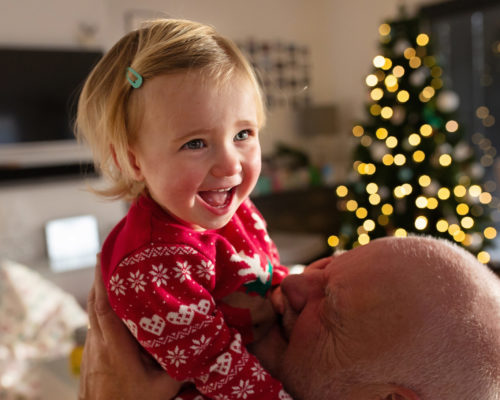 DIY Christmas photography, festive photography, Woking baby photographer, family photos, Baby girl laughing with Grandad, Grandad and granddaughter