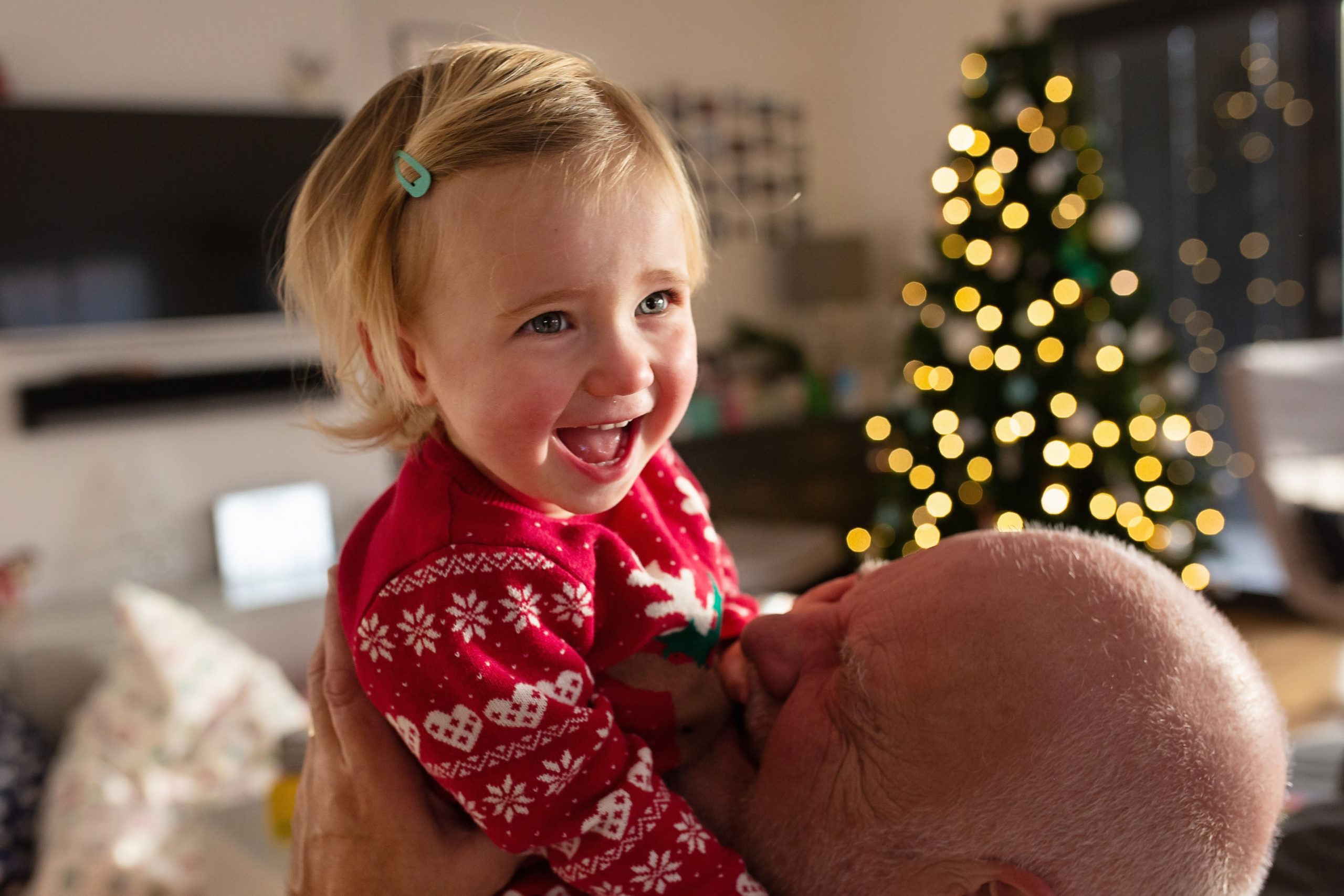 DIY Christmas photography, festive photography, Woking baby photographer, family photos, Baby girl laughing with Grandad, Grandad and granddaughter