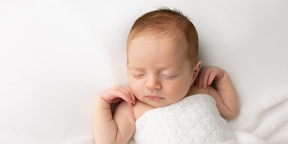 Newborn baby girl sleeping during newborn session in Surrey