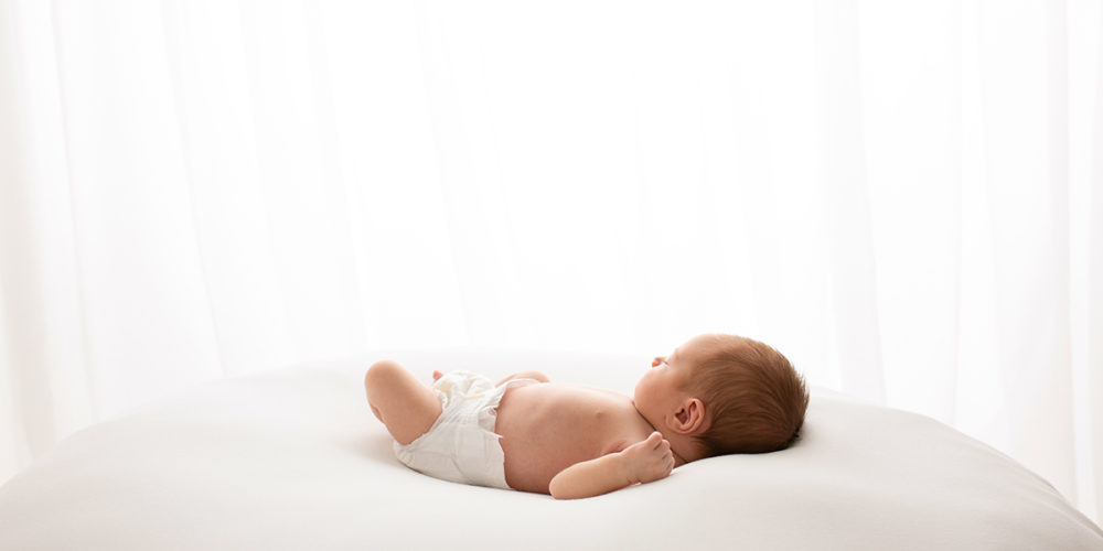 Baby girl sleeping during newborn photoshoot in Surrey