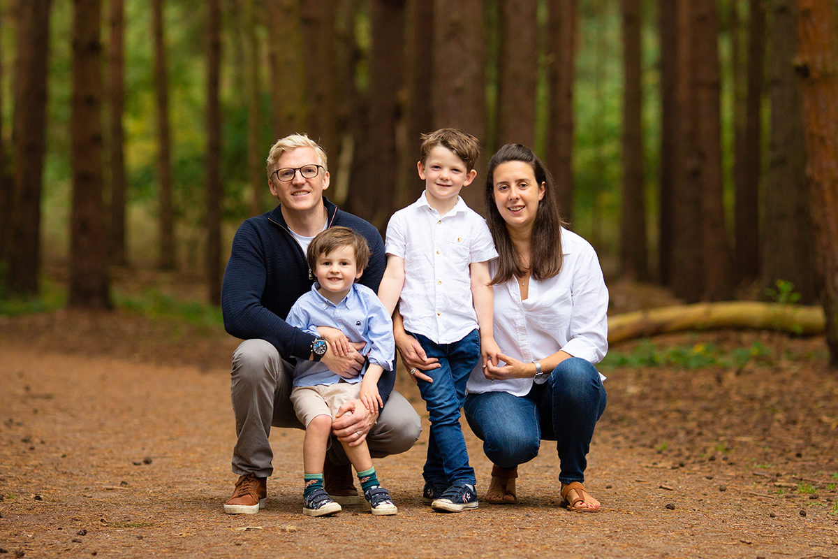 Family of four smiling on family photoshoot in Woking