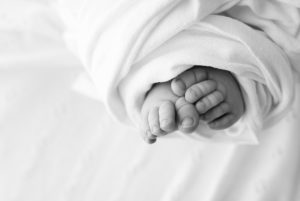 Baby feet wrapped up during newborn photoshoot in Woking