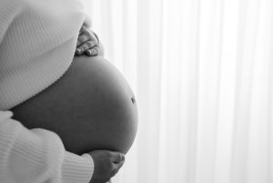 Black and white pregnancy belly during maternity photoshoot in Woking
